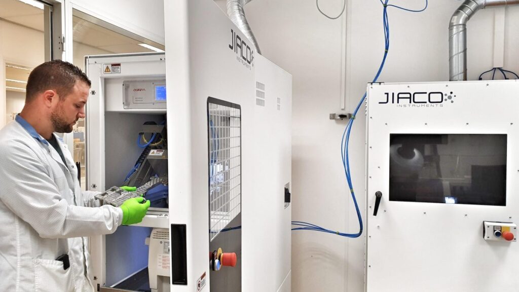 Engineer using a JIACO Instruments MIP Decapsulation machine.